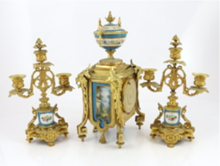 A 19th century French ormolu and Sevres style porcelain clock garniture, clock 19cm wide, 15cm deep, 37cm high candelabra 19cm wide, 30.5cm high